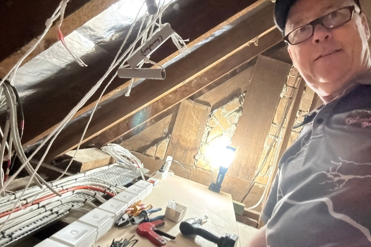 Electrician working in the roof space of the home