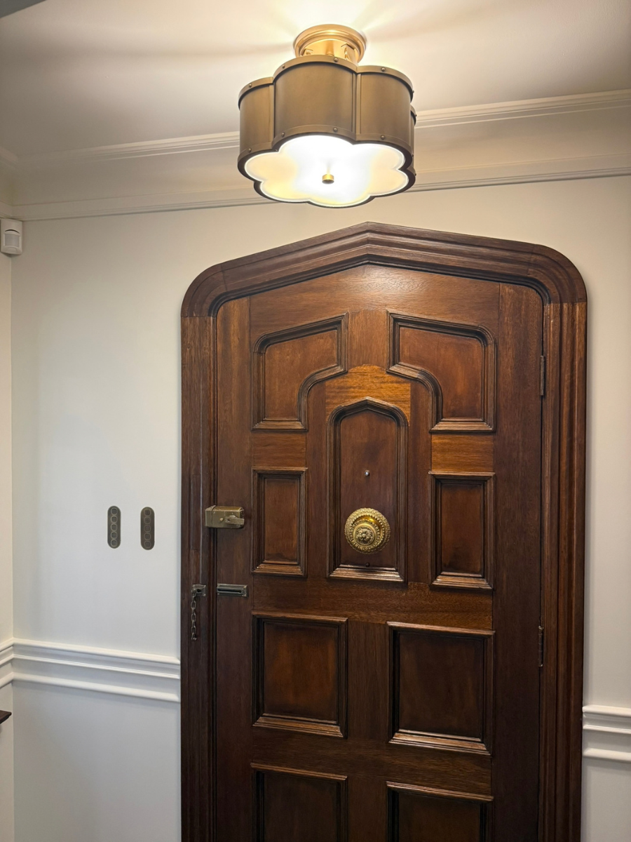 Flush-mounted brass ZETR wall plates beside a timber door